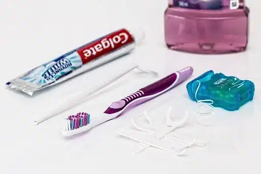 colgate tooth paste and a tooth brush